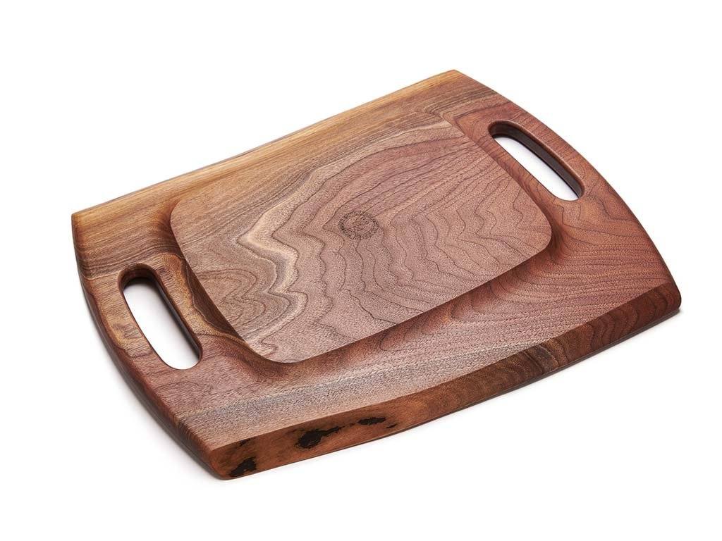 The Marsh charcuterie board features a raised bottom with carved handles in each end for easy lifting and carrying.